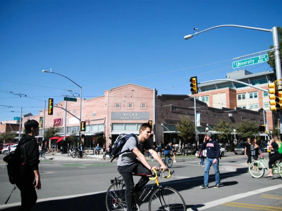 Intersection next to campus with students walking and biking