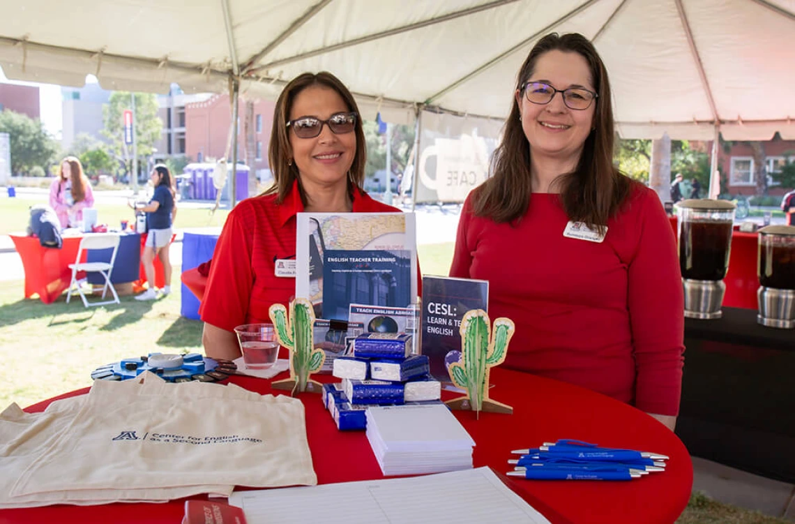 Faculty and staff members manning a CESL table at Homecoming